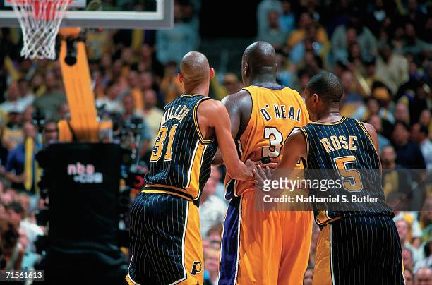 Shaquille O'Neal of the Los Angeles Lakers battles for position against Reggie Miller and Jalen Rose of the Indiana Pacers during Game Two of the...
