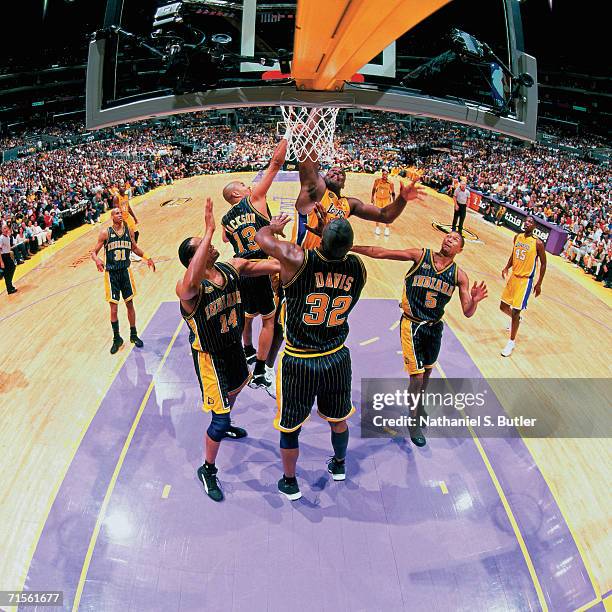 Shaquille O'Neal of the Los Angeles Lakers attempts a shot against Dale Davis of the Indiana Pacers during Game Two of the 2000 NBA Finals on June 9,...