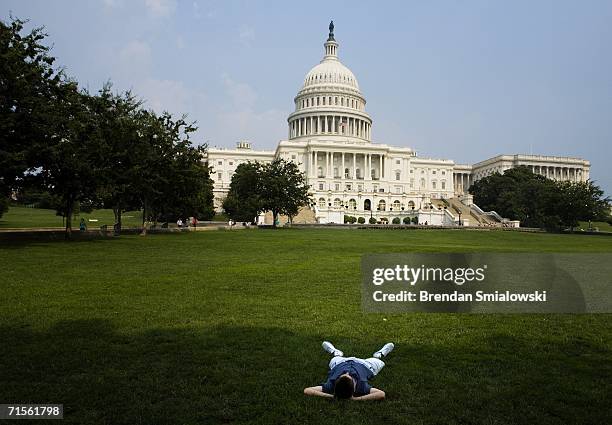 Visitor to the US Capitol lays in the shade near the Capitol Building August 1, 2006 in Washington, DC. The national weather service forecasted a...