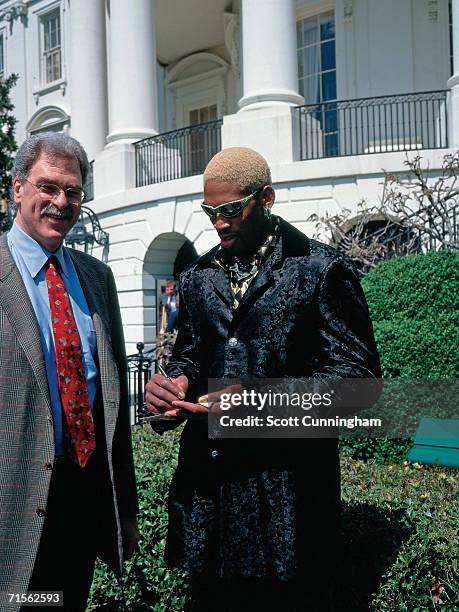 Dennis Rodman of the Chicago Bulls signs an autograph during the team's visit to the White House on April 3, 1997 in Washington, D.C. NOTE TO USER:...