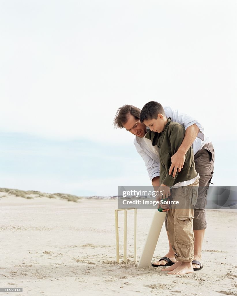 Pai e filho brincando de Críquete