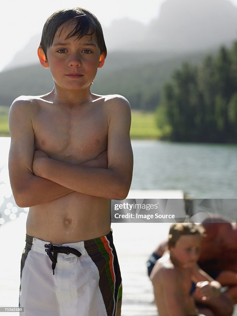 Boy standing on a pier
