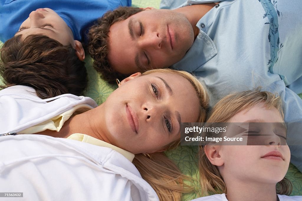 Family lying on a blanket