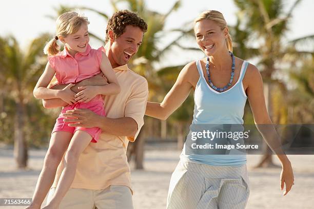 girl and parents having fun - beach florida family stockfoto's en -beelden