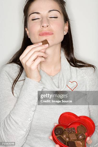 woman enjoying chocolate - chocolate tasting stock pictures, royalty-free photos & images