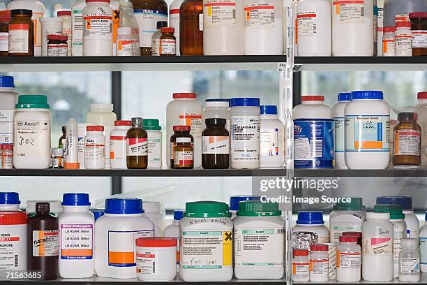 chemicals on a shelf - chemical lab stock pictures, royalty-free photos & images