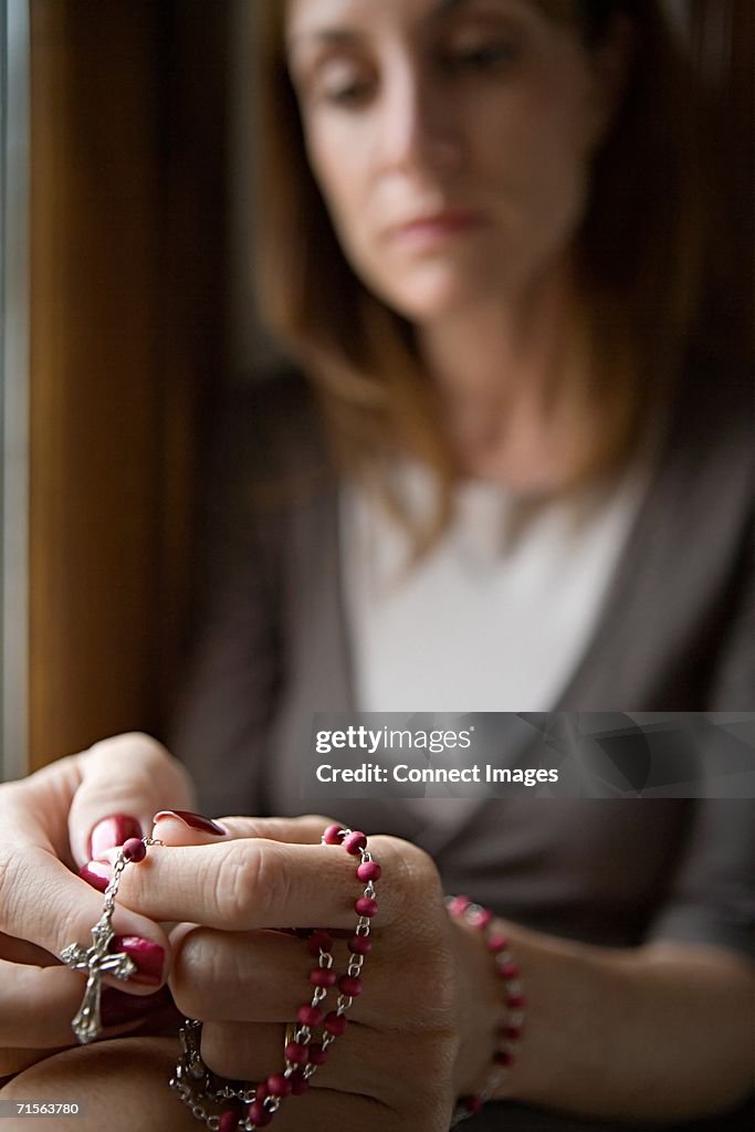 Woman holding rosary