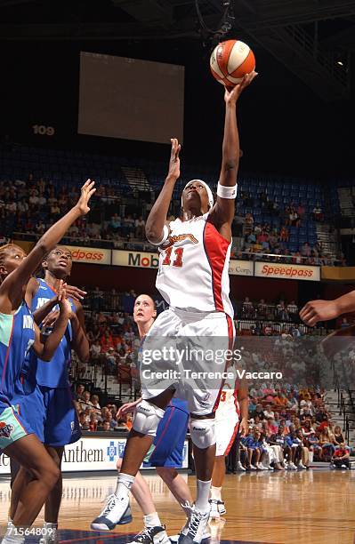 Taj McWilliams-Franklin of the Connecticut Sun goes to the basket against the New York Liberty on August 1, 2006 at Mohegan Sun Arena in Uncasville,...