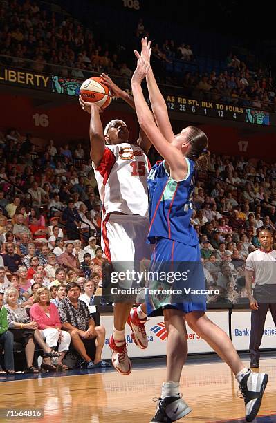 Asjha Jones of the Connecticut Sun shoots against Cathrine Kraayeveld of the New York Liberty on August 1, 2006 at Mohegan Sun Arena in Uncasville,...