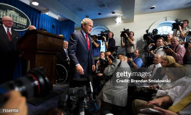 President George W. Bush walks toward the front row of press final conference at the White House before the briefing area is temporarily closed...