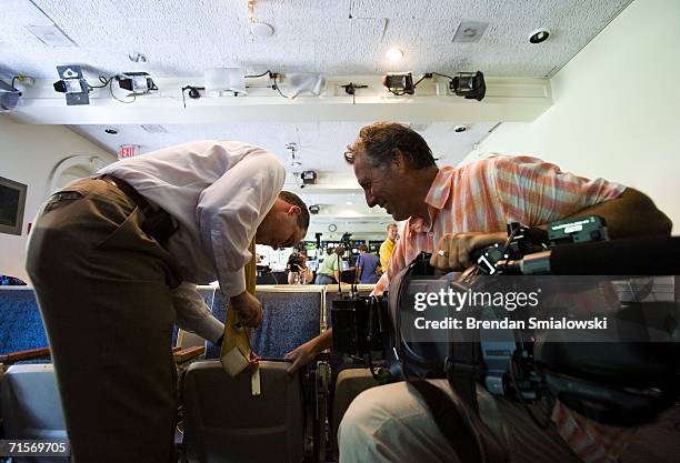 Camera crew removes the name plate on a seat in the press briefing room of the White House August 2, 2006 in Washington, DC. White House press corps...