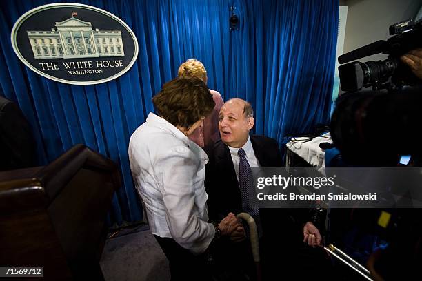 Helen Thomas speaks with former Ronald Reagan Press Secretary James Brady after the final conference at the White House before the briefing area is...