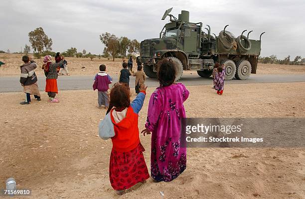 "najaf, iraq (january 24, 2005) ? iraqi children wave to an american convoy that passes on a local road." - iraq stock pictures, royalty-free photos & images