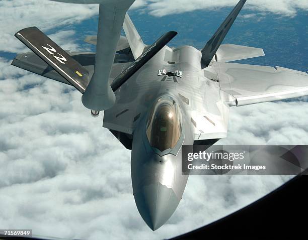 "over the united states (afpn) - an f-22a raptor from langley air force base, va., refuels with a kc-135 stratotanker from mcconnell afb, kansas, during the raptor's first operational mission january 21." - langley air force base stock pictures, royalty-free photos & images