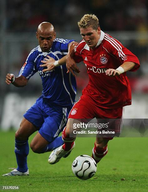 Gustavo Varela of Schalke challenges Bastian Schweinsteiger of Bayern Munich during the semi final of the Liga Cup match between Bayern Munich and FC...