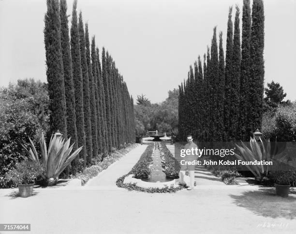 American silent era comedian Harold Lloyd in the garden of Greenacres, his palatial Spanish-style villa in Beverly Hills, circa 1930.