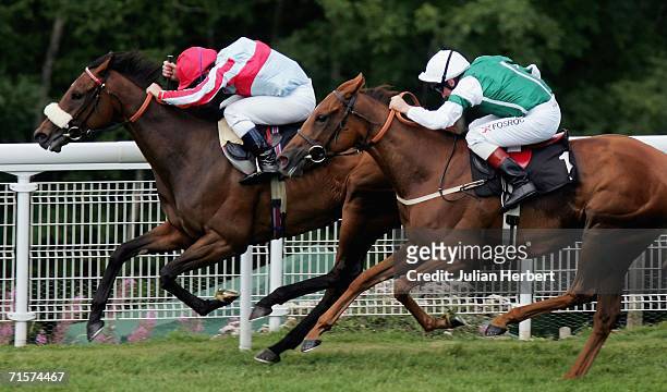 Seb Sanders and Tartouche get the better of the John Egan ridden Art Eyes to land The Lillie Langtry Fillies Stakes Race run at Goodwood Racecourse...