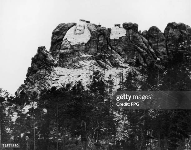 Construction begins on the Mount Rushmore National Memorial in South Dakota, circa 1929. The face of US president George Washington is already...