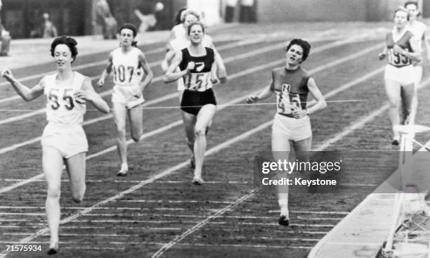 British runner Ann Packer, no. 55, breaking the world record to win the gold medal in the 800 metres event at the Tokyo Olympics, 21st October 1964....