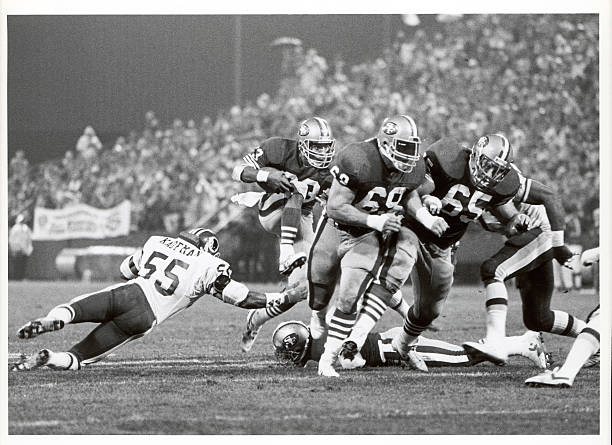 Offensive guards Bruce Collie and Jeff Bregel of the San Francisco 49ers block for running back Roger Craig during the Monday Night Football game...