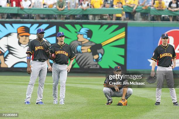 American League All-Stars Gary Matthews Jr. #14, Michael Young, Ivan Rodriguez, and Mark Loretta stand together during practice for the 77th MLB...