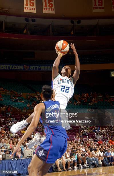 Ashley Battle of the New York Liberty shoots against Kedra Holland-Corn of the Detroit Shock at Madison Square Garden, in New York City on August 3,...