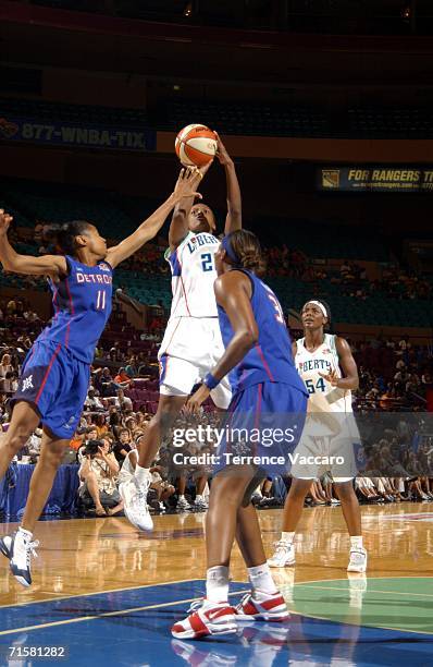 Ashley Battle of the New York Liberty shoots against Kedra Holland-Corn and Cheryl Ford of the Detroit Shock at Madison Square Garden, in New York...