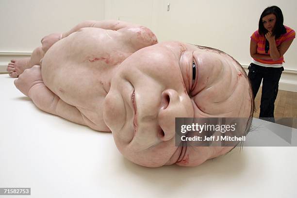 Visitors to the National Galleries of Scotland view the work of Australian born, London based sculptor Ron Mueck on August 4,2006 Edinburgh in...