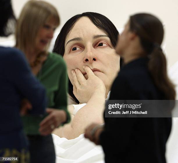 Visitors to the National Galleries of Scotland view the work of Australian born, London based sculptor Ron Mueck on August 4, 2006 Edinburgh in...
