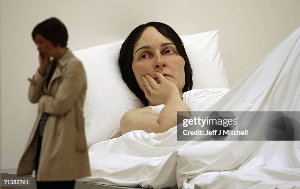 Visitors to the National Galleries of Scotland view the work of Australian born, London-based sculptor Ron Mueck on August 4,2006 Edinburgh in...
