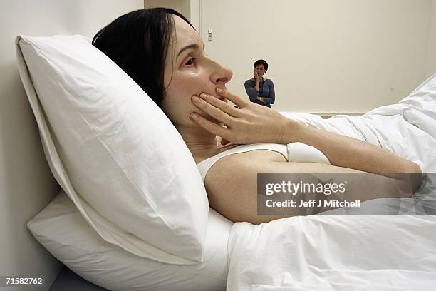 Visitors to the National Galleries of Scotland views the work of Australian born, London based sculptor Ron Mueck on August 4,2006 Edinburgh in...
