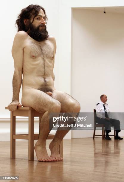 Security guard looks on at the National Galleries of Scotland as visitors view the work of Australian born, London-based sculptor Ron Mueck August...