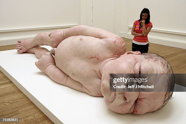 Visitor to the National Galleries of Scotland views the work of Australian born, London-based sculptor Ron Mueck on August 4, 2006 Edinburgh in...