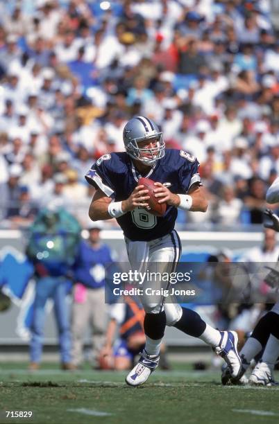 Quarterback Troy Aikman of the Dallas Cowboys moves back to pass the ball during the game against the Carolina Panthers at the Ericsson Stadium in...
