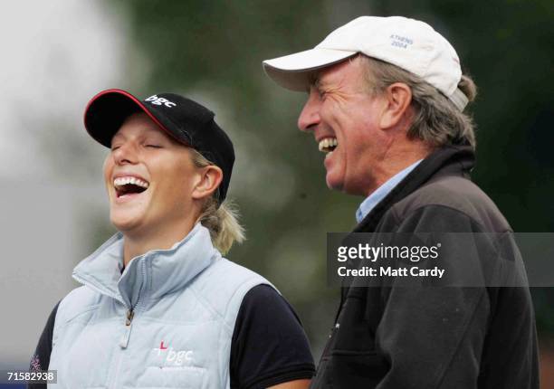 Zara Phillips and her father Captain Mark Phillips laugh together on the first day of the Gatcombe Horse Trials on the Gatcombe Estate on August 4,...