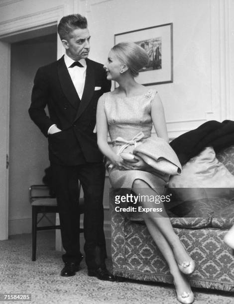 Austrian conductor Herbert von Karajan with his wife Eliette, a former model, in their London hotel suite, 6th April 1962. Von Karajan is in the...