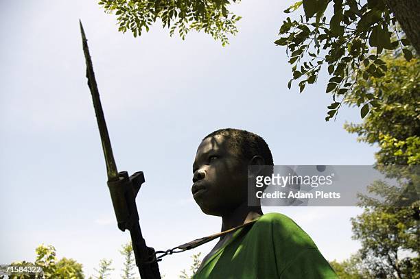 One of the many young boys who fight in the Lords Resistance Army stands guard as LRA leader Joseph Kony meets with the Southern Sudanese vice...
