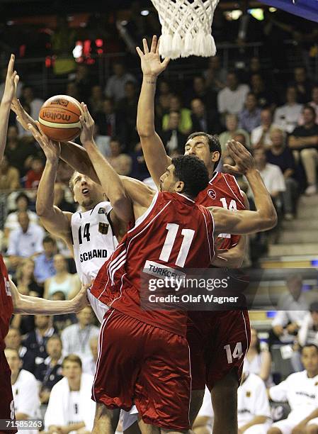 Dirk Nowitzki of Germany shoots against Fatih Solak and Kaya Peker of Turkey during the Basketball Super Cup match between Germany and Turkey on...