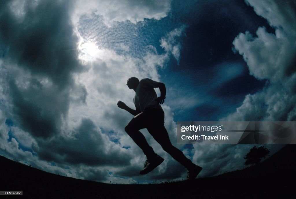Silhouette of a Man Jogging - Low Angle