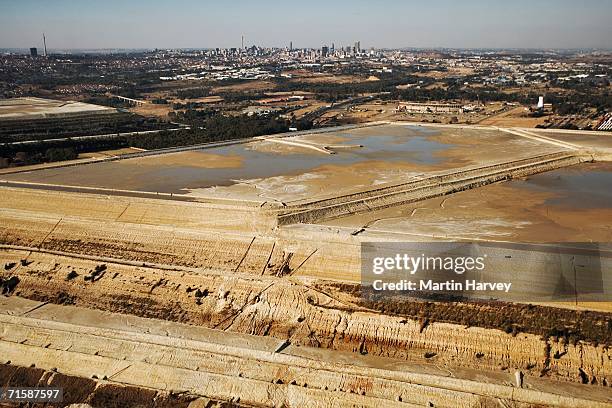 aerial view of mine dump with johannesburg cbd in background - relave fotografías e imágenes de stock