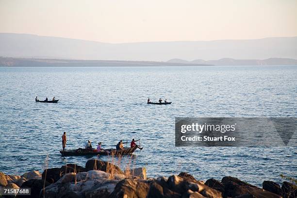 local zambian fishermen in 'plank' boats - tanganyikasjön bildbanksfoton och bilder