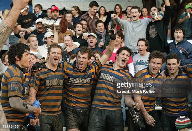 The Sydney University players and supporters sing the club song to celebrate their victory and securing the club championship during the Tooheys New...