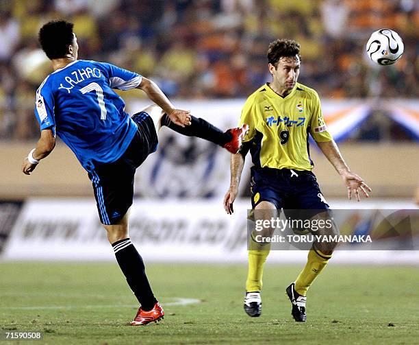 China's Dalian Shide midfielder FC Zhao Xu Ri battles for the ball with Japanese club JEF United Chiba midfielder Nebojsa Krupnikovic during their...