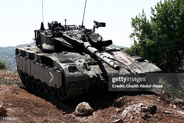 Disabled, and partially burned Merkava tank is seen August 5, 2006 in the southern Lebanese village of Ait el-Sha'ab. Ait El-Shaab has been the scene...