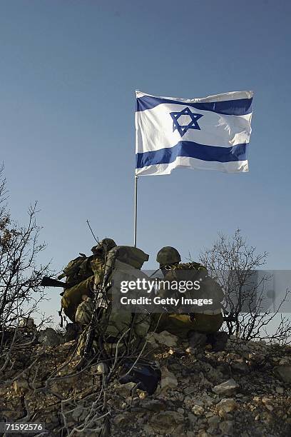 In this photo released by the Israel Defense Forces , Israeli soldiers raise their national flag at the army's new Sahlab outpost August 5, 2006 in...