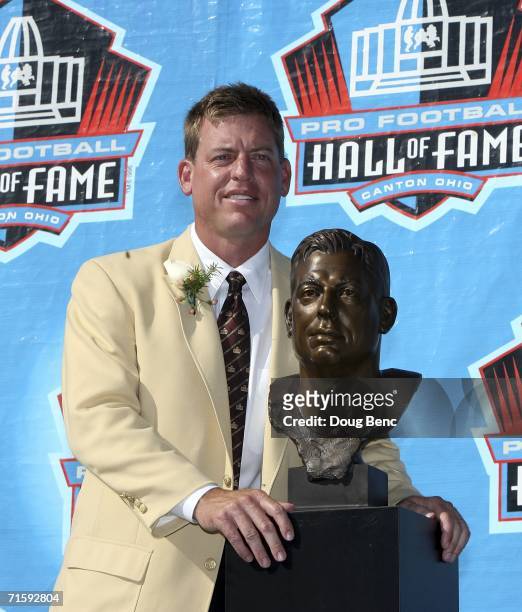Quarterback Troy Aikman of the Dallas Cowboys poses with his bust after his induction during the Class of 2006 Pro Football Hall of Fame Enshrinement...