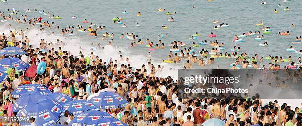 Swimmers pack the Dameisha Bathing Beach on August 1, 2006 in Shenzhen of Guangdong Province, China. With the advent of the travel season, bathing...