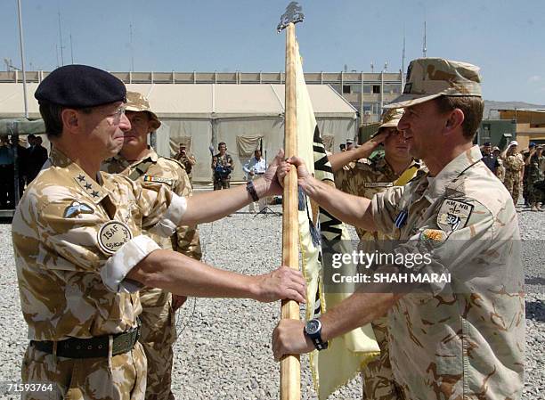Bulgarian Brigadier General Neyko Nenov hands over the Kabul Multi- National Brigade's flag to British Lieutenant General David Richards, commander...