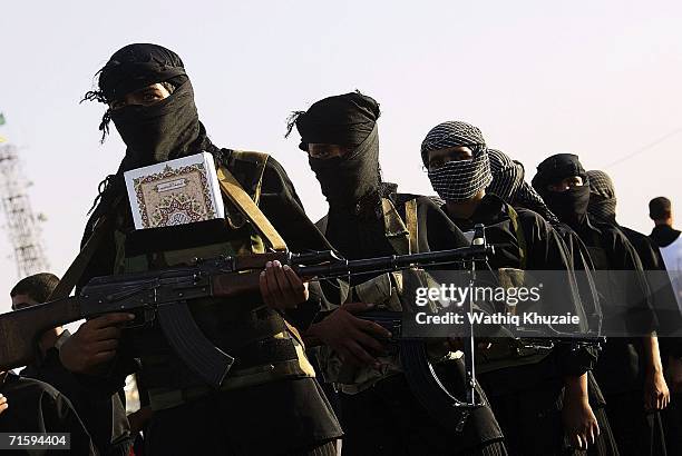 August 5 : Iraqi militiamen of al-Mahdi army, loyal to Shiite cleric Moqtada al-Sadr, carry their guns during a parade to mark the 2nd anniversary of...