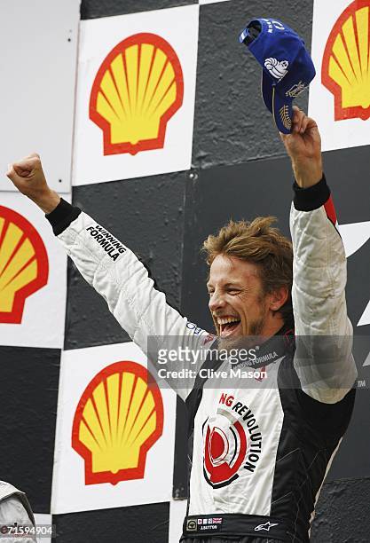 Jenson Button of Great Britain and Honda Racing celebrates victory on the podium after the Hungarian Formula One Grand Prix at the Hungaroring on...